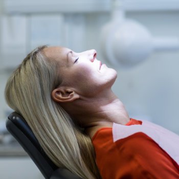 Relaxed female dental patient under sedation