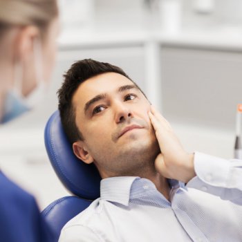 a man with a toothache during a dental appointment