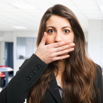 brunette covering her mouth with her hand
