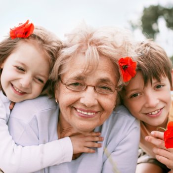 smiling grandmother with two grandchildren